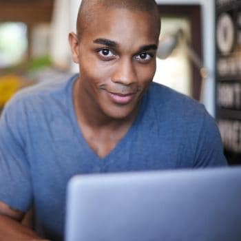 young man using his laptop in a coffee shop