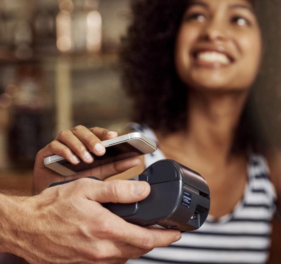 Woman using Apple pay on iPhone