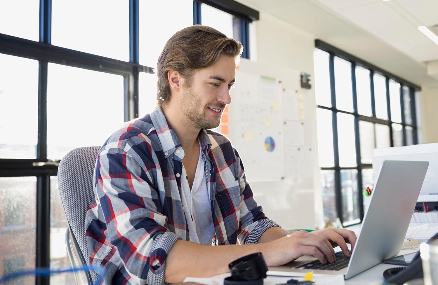 Man working on laptop in office building