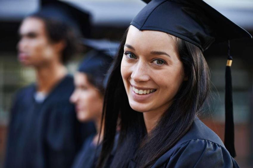 Recent college graduate smiling at camera