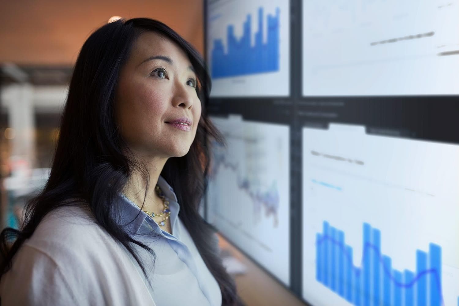 Woman looking at data on screens