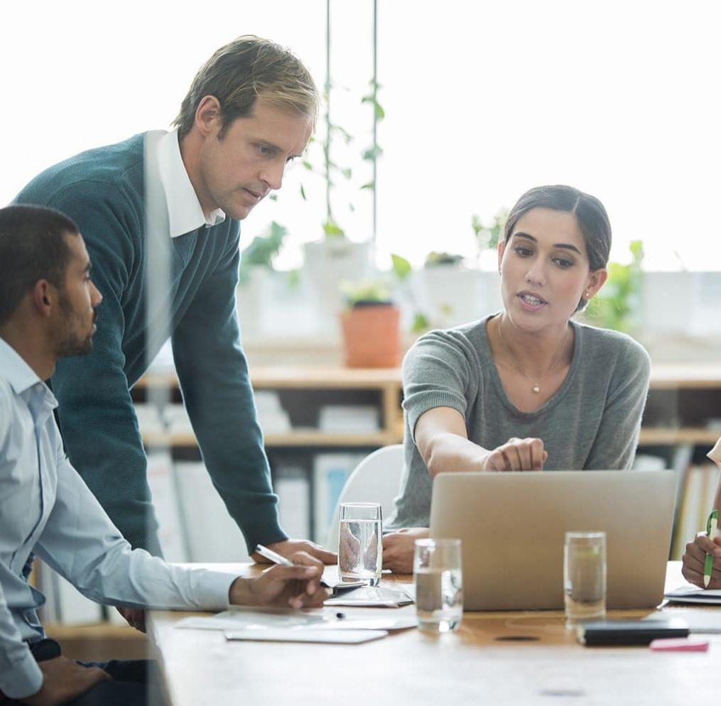 Group of coworkers having discussion in office