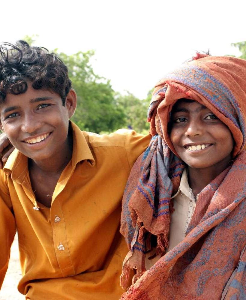 Young refugee boys hugging and smiling