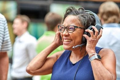 Happy female SAS employee smiling and wearing headset