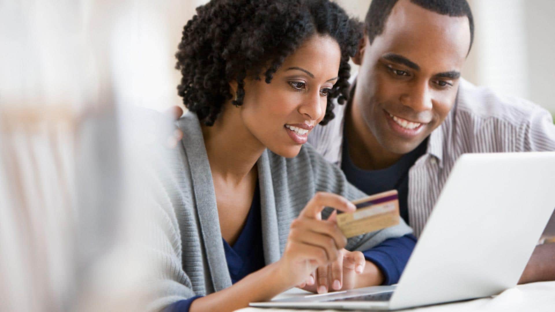 Yougn couple shopping online with credit card