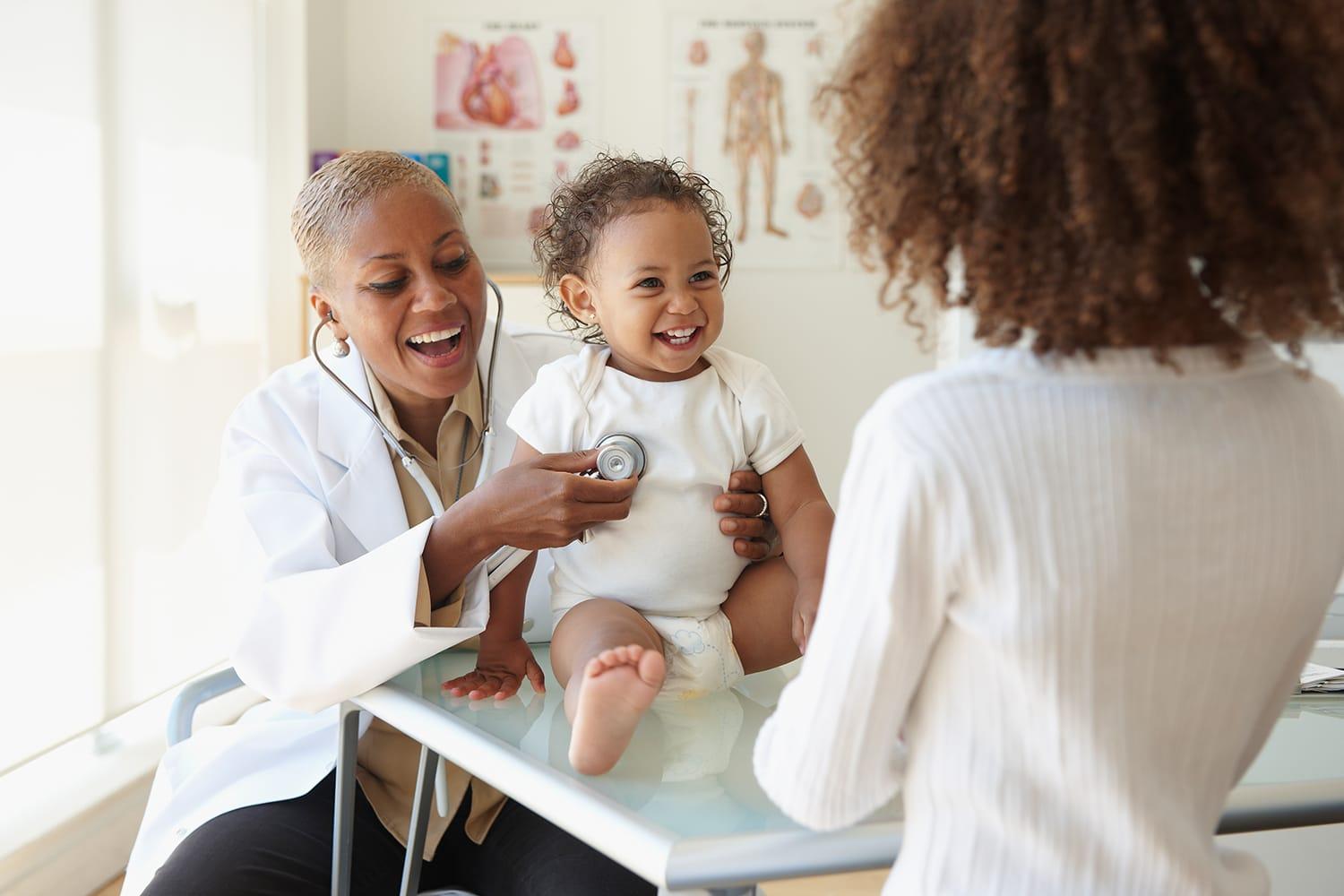 Doctor listening to baby breathing with stethoscope