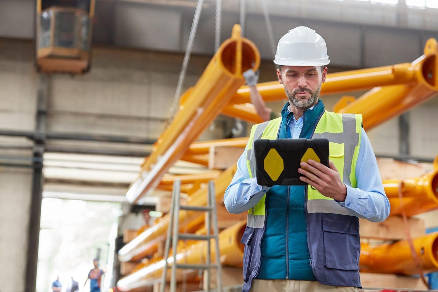 Person in safety vest holding a tablet