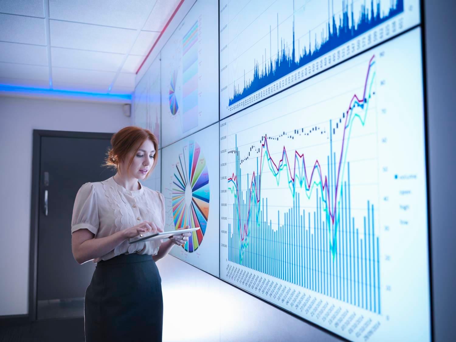 Woman reviewing data on large screen