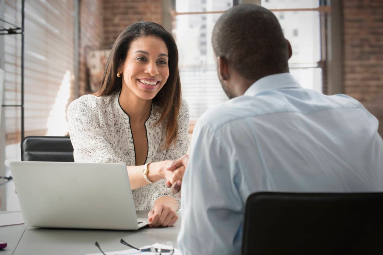 Business person shaking hands with client