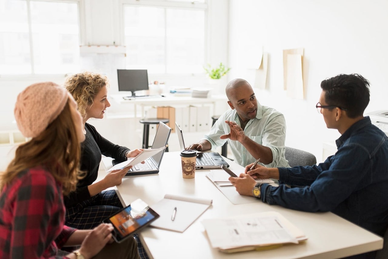 Young team of coworkers holding brainstorming session