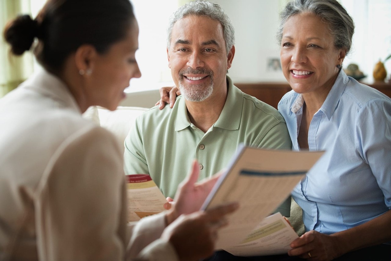 Businesswoman talking to couple
