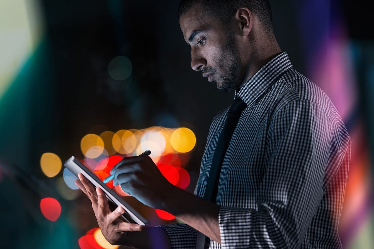 Young businessman outdoors with tablet device