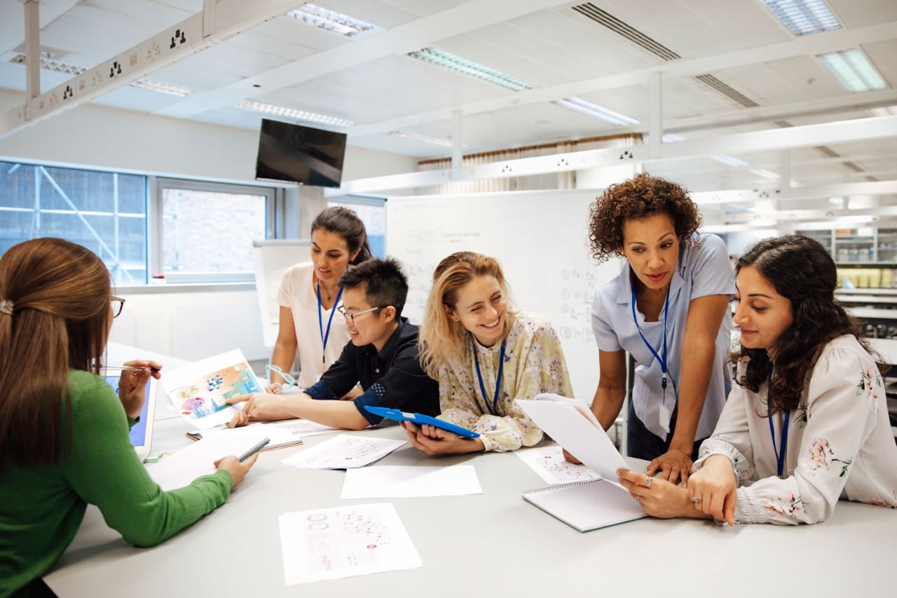 Teacher collaborating with students