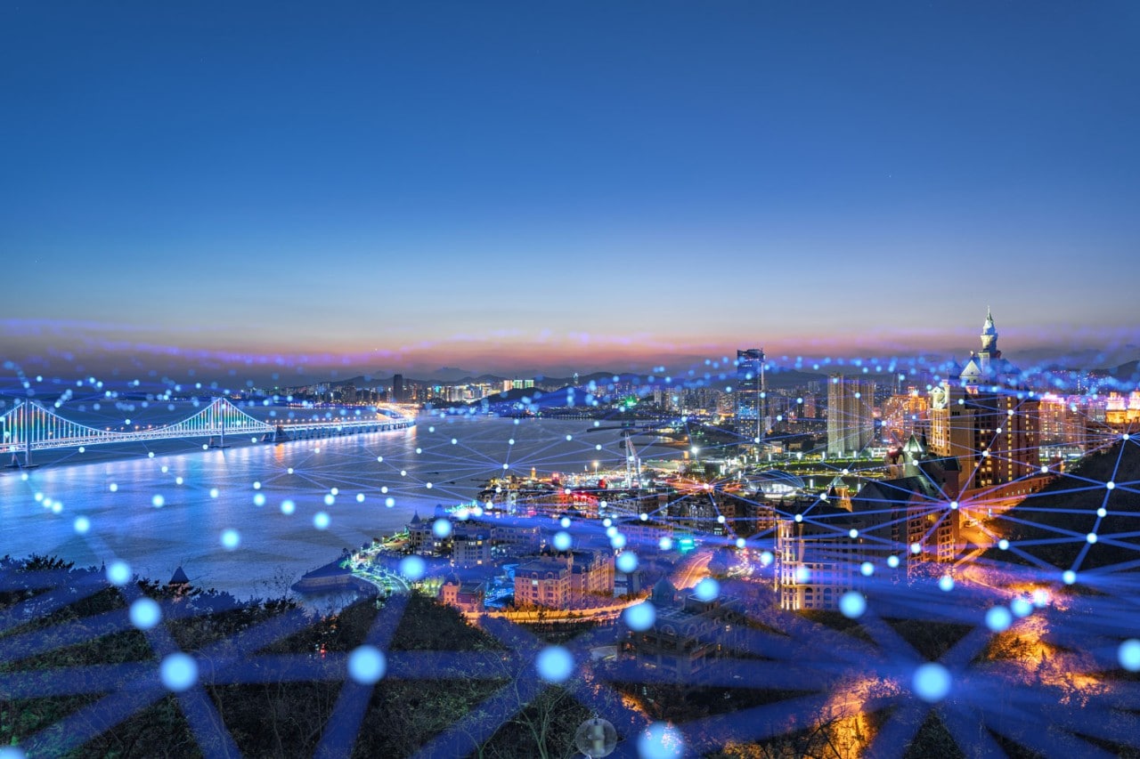Colorful city scape at night with lights connecting the area