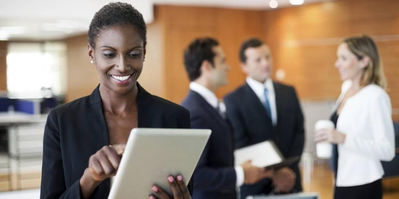 African American woman with tablet in office setting African American woman with tablet in office setting