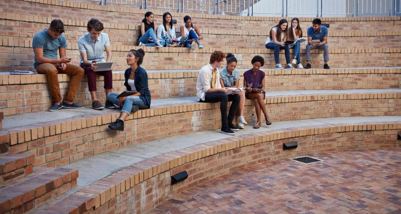 SAS Academic Software Students sitting on steps using devices