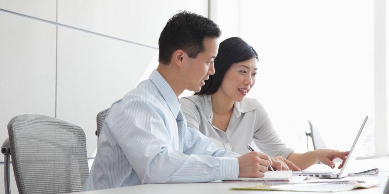 Male and female coworkers in bright open office Male and female coworkers in bright open office