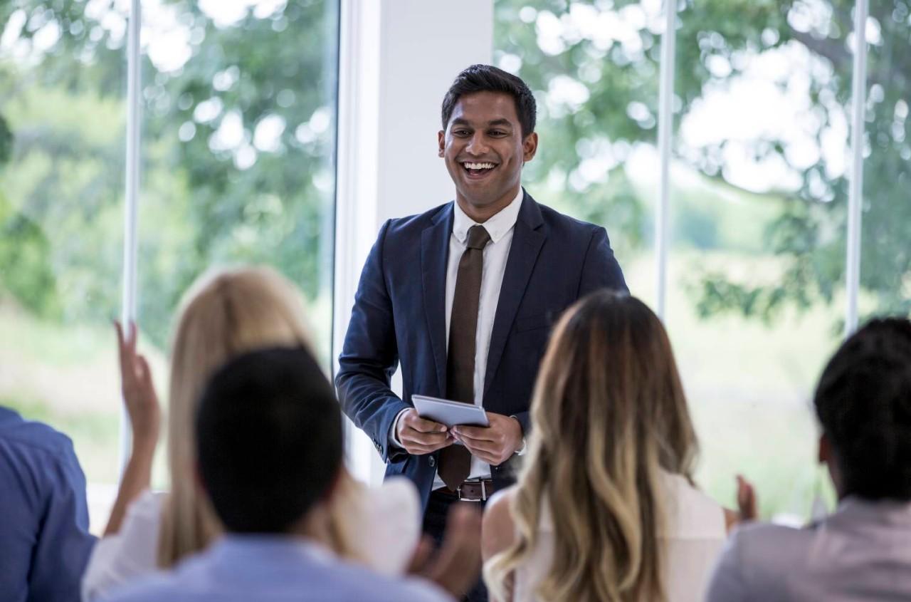 Educator in front of classroom of peers
