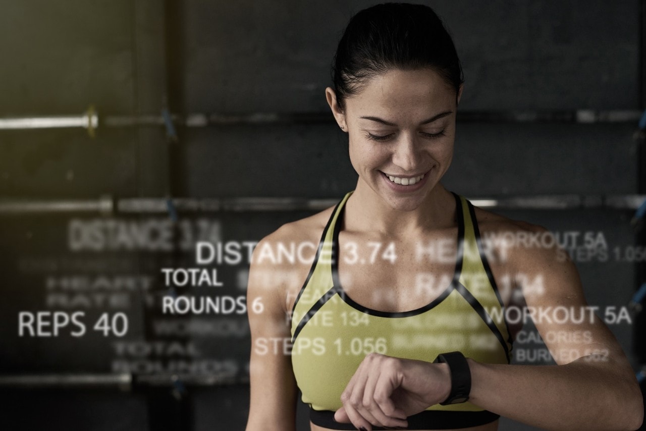 Woman checking her smart watch for health data after exercising
