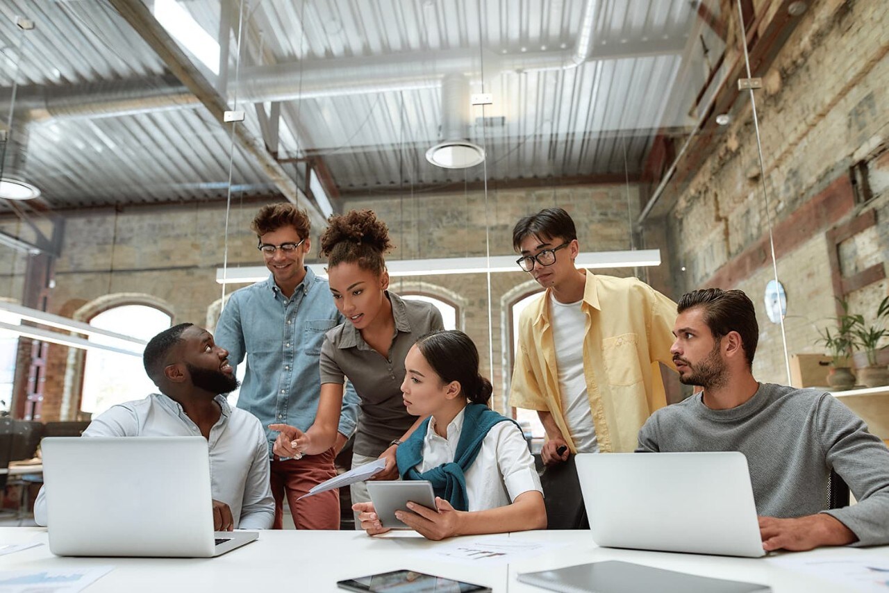 Individuals collaborating on project in conference room office