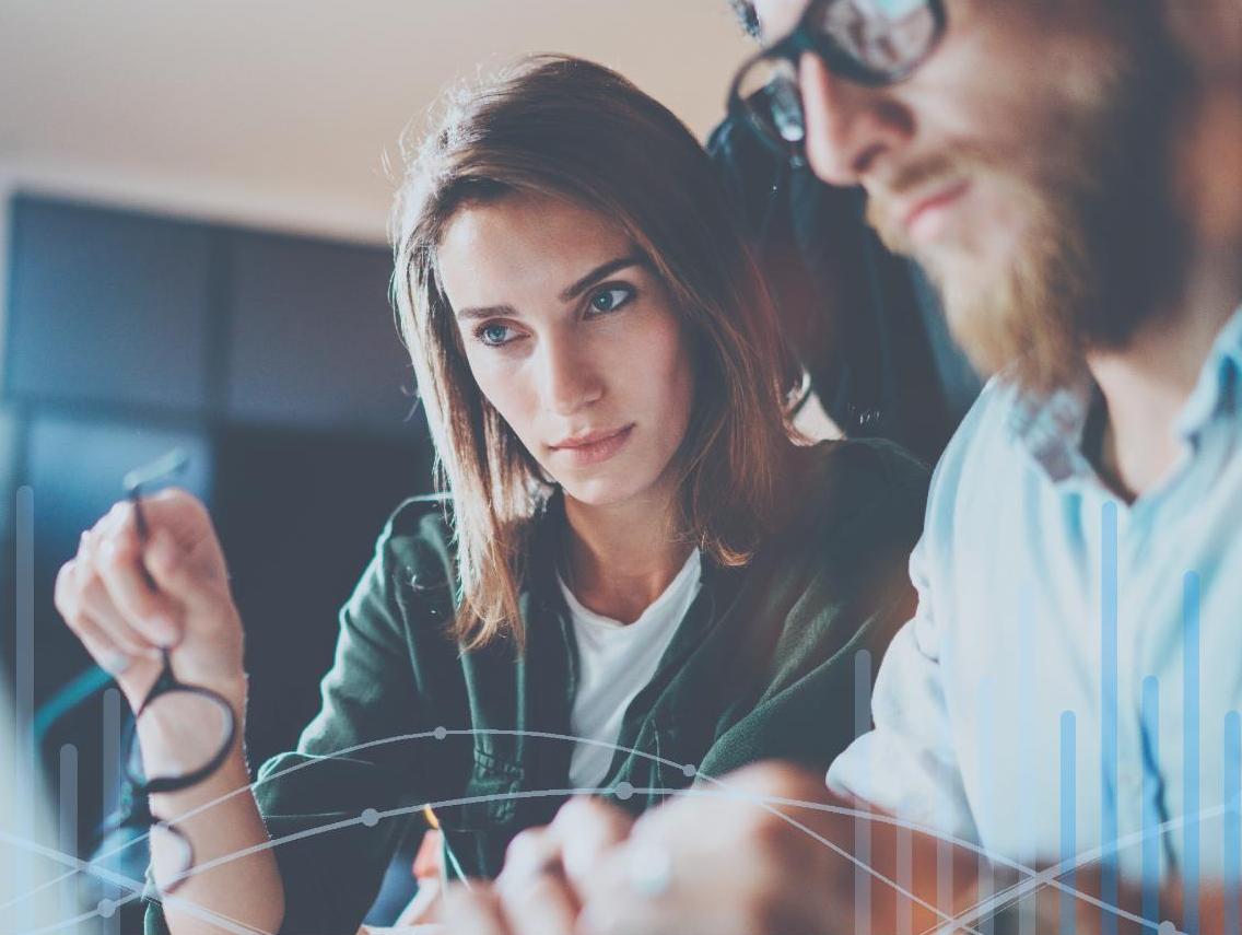 Man and woman looking at data on laptop