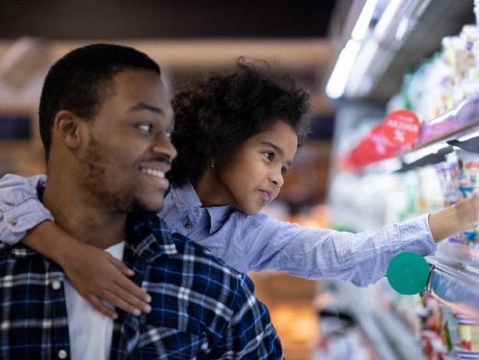 Father and daughter grocery shopping