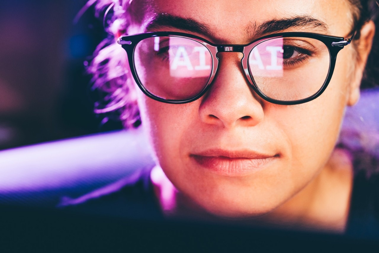 "AI" reflects in woman's glasses