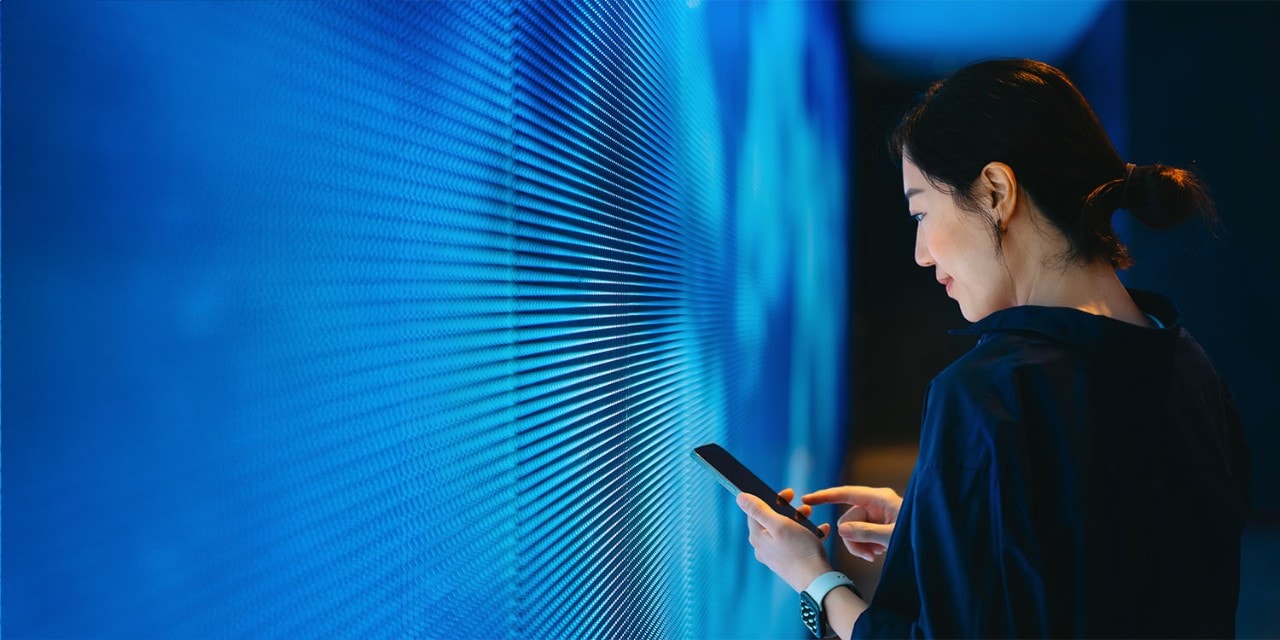 About SAS Woman looking at data points on screen