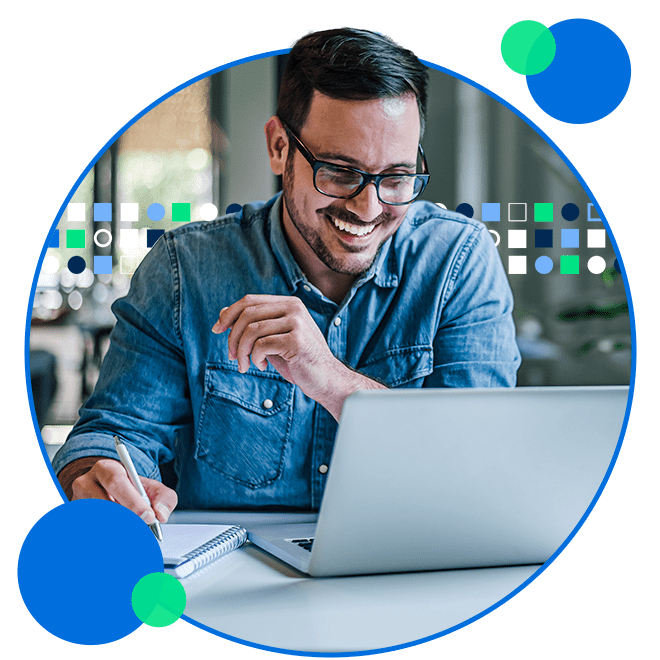Young businessman smiling in casual workwear with laptop