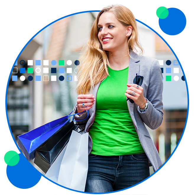 Young female walking outdoors with shopping bags and sunglasses